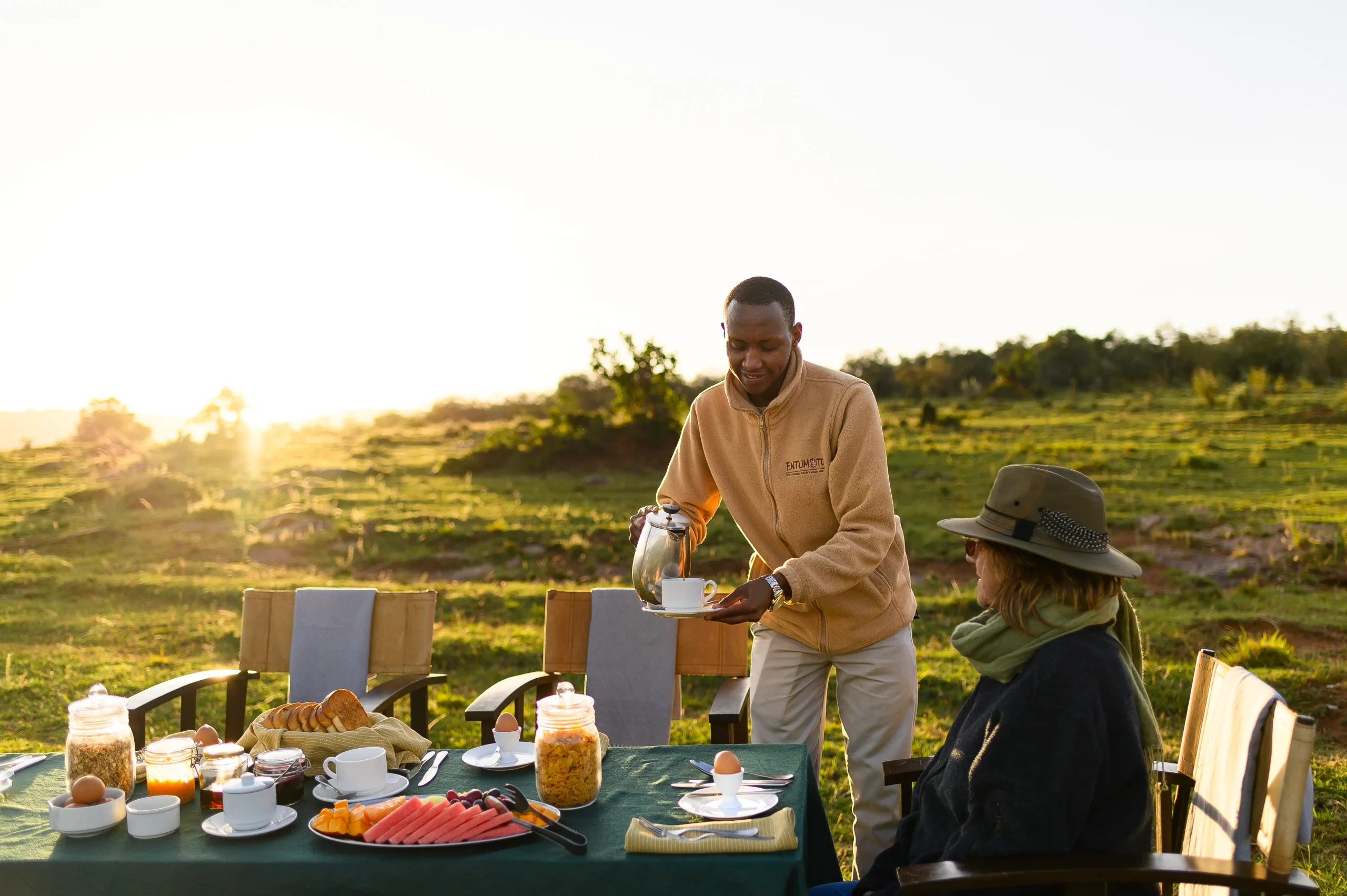 Bush breakfast with staff pouring tea in the Maasai Mara, Entumoto Safari Camp. Photo: Vanessa Knight